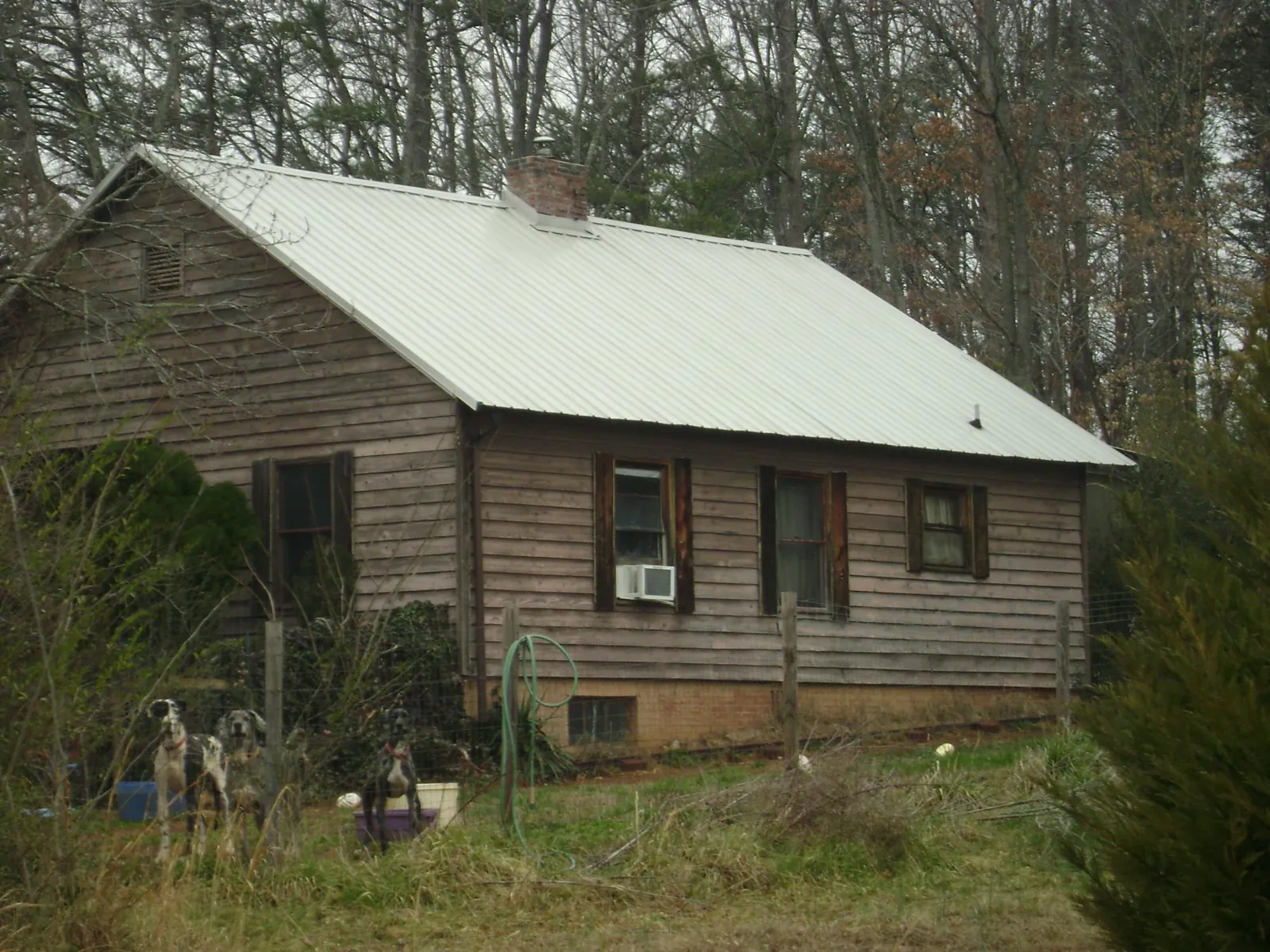 White metal roof on an old wood sided farmhouse, from a Metal Roof Installation job in Greenwood Springs
